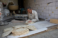 A man making bread in an Iranian bakery