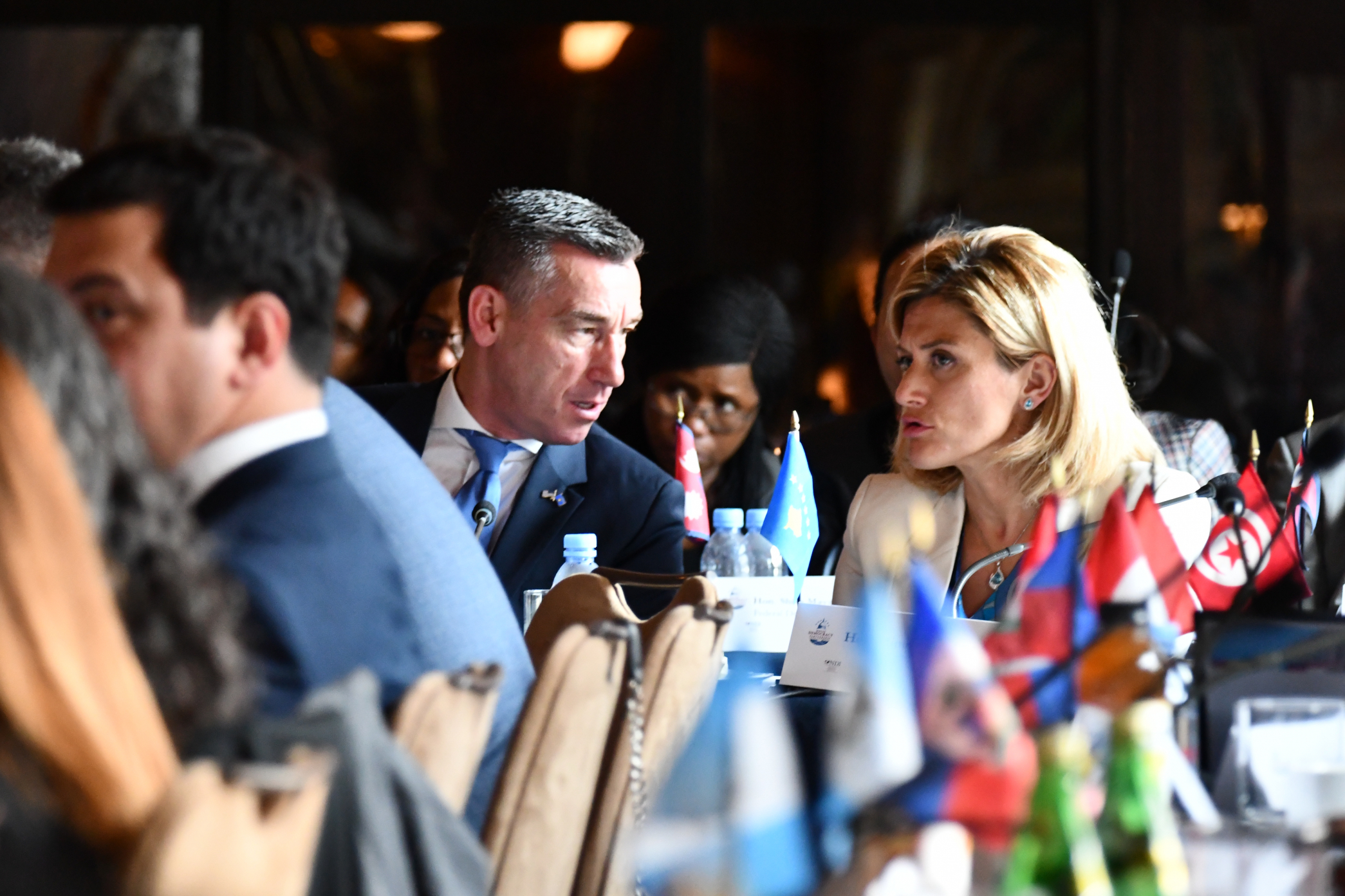 Hon. Kadri Veseli, Speaker of the Assembly of the Republic of Kosovo (left), speaks to Hon. Mimoza Kusari-Lila, Member of the Assembly of the Republic of Kosovo (right) during a panel discussion on combating polarization and enhancing cross-party communic