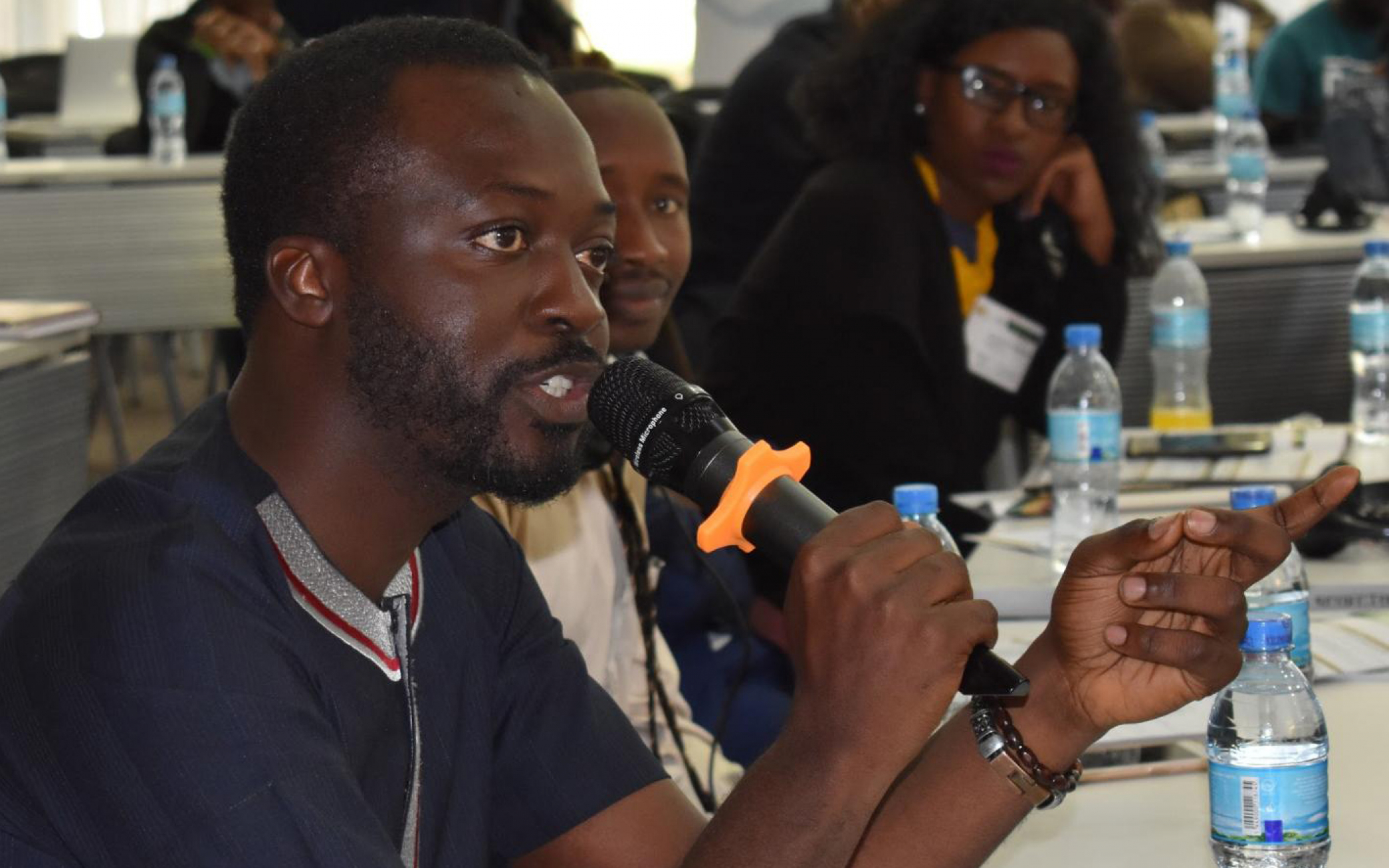 A participant during the Southern and East Africa regional youth consultations in Arusha, Tanzania, poses a question during a plenary session.  