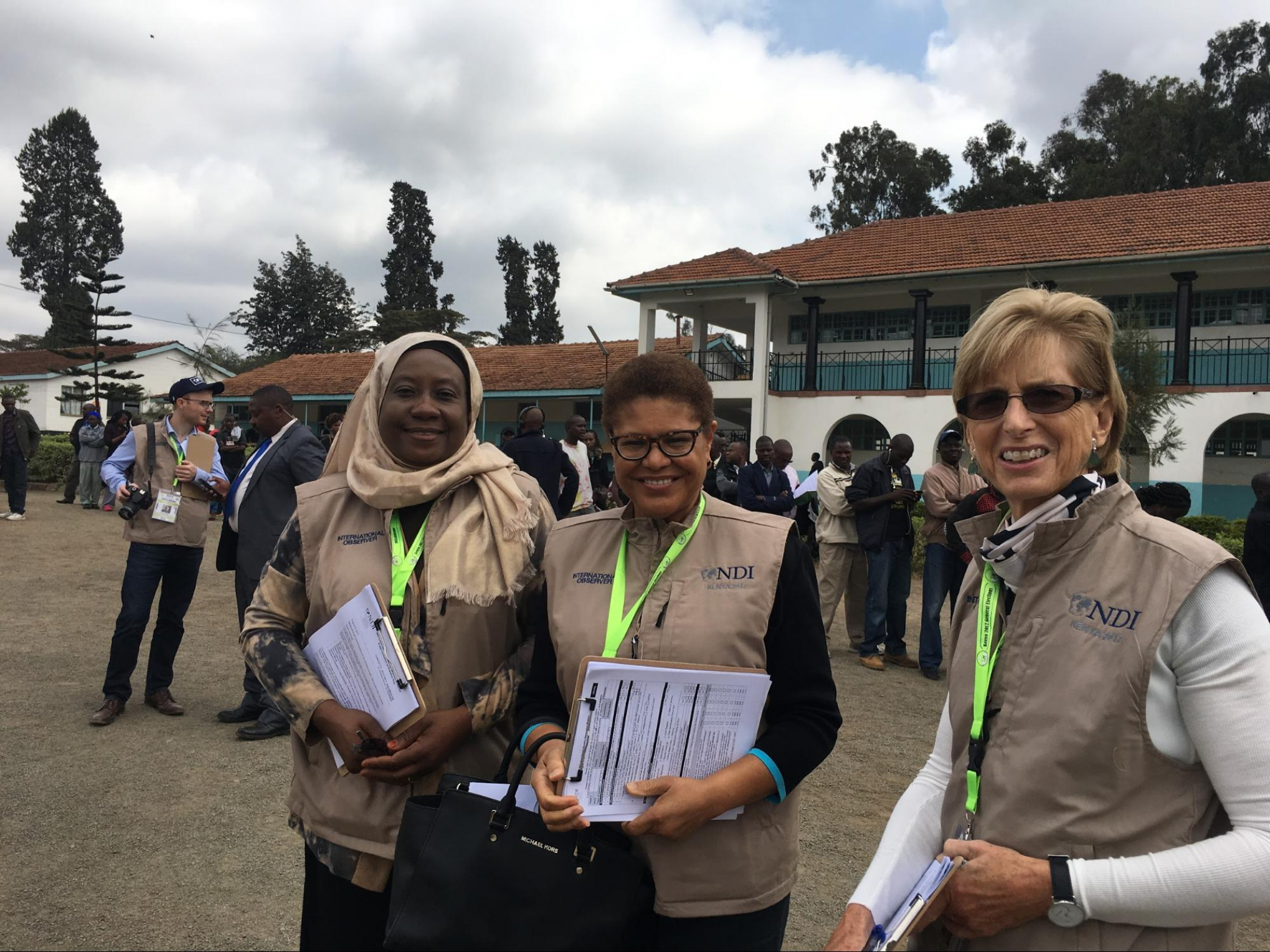 Ambassador Abdullahi, Rep. Bass, and former Governor Whitman have their observer vests and checklists at hand on Election Day.