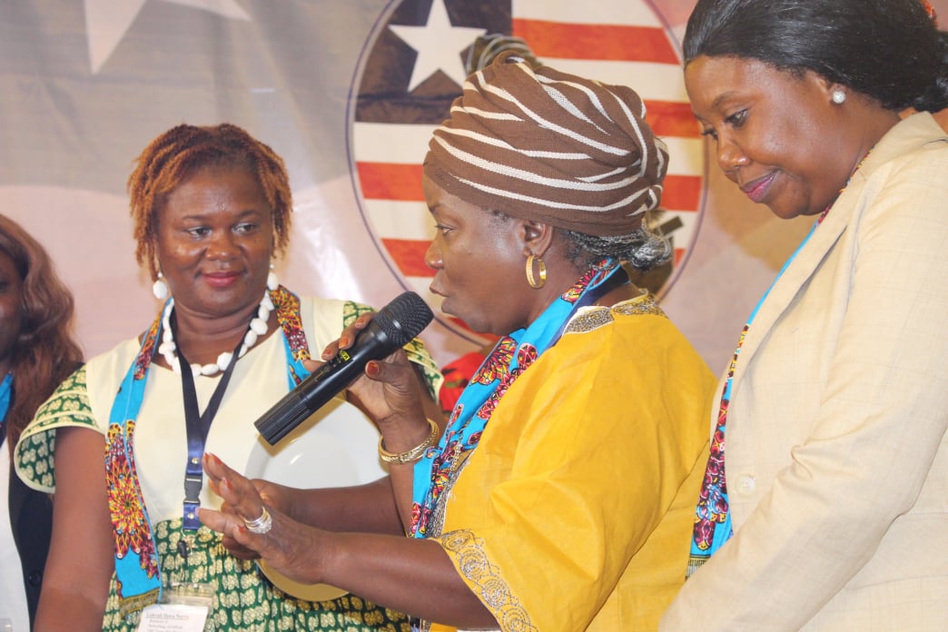 A Liberian woman practices her public speaking skills during a workshop