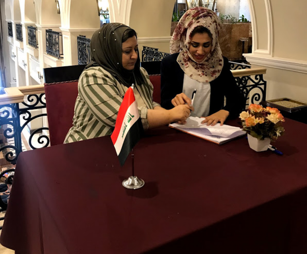 Newly-elected members of the Salahaddin WAB’s executive committee sign their bylaws into effect. Photo credit: NDI-Iraq