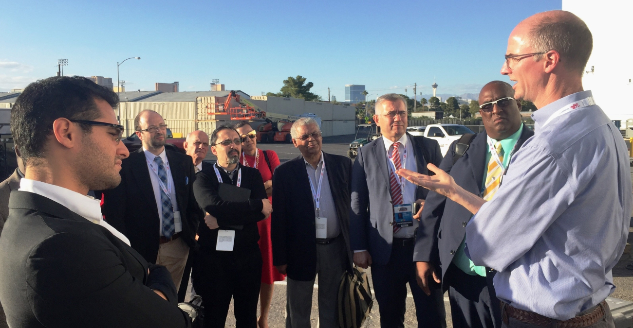 International delegates with media TV production expertise are briefed by the FOX Special Events Pool director at the production truck outside the Thomas and Mack Center debate hall at the University of Nevada, Las Vegas at the Debate Visit and CPD-NDI In