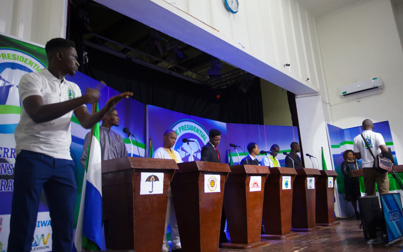 A sign language interpreter makes sure that Sierra Leoneans of all hearing levels have access to the youth candidate debate. Credit: Vickie Remoe