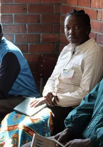 Party agents in a polling station in Harare, with their observation materials, notebooks and identifying accreditation, watch on as citizens vote the July 30th elections in Zimbabwe.
