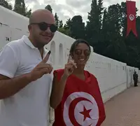 Tunisian voters display inked fingers indicating they've voted in the September 15, 2019, presidential election.