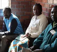 Party agents in a polling station in Harare, with their observation materials, notebooks and identifying accreditation, watch on as citizens vote the July 30th elections in Zimbabwe.