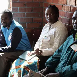 Party agents in a polling station in Harare, with their observation materials, notebooks and identifying accreditation, watch on as citizens vote the July 30th elections in Zimbabwe.