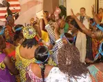 Liberian women participate in a role-playing workshop to practice encouraging rural women to register to vote. 