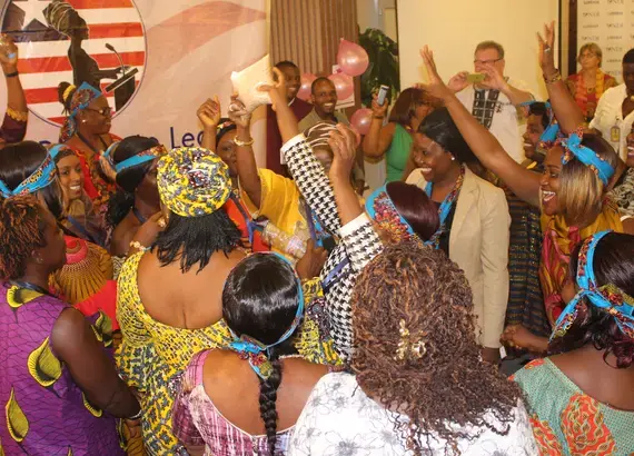 Liberian women participate in a role-playing workshop to practice encouraging rural women to register to vote.