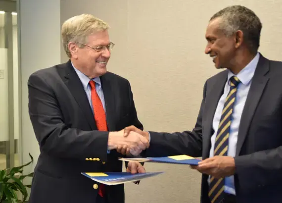 NDI President Kenneth Wollack and IGAD Executive Secretary Amb. Mahboub Maalim shake hands following the signing of an MoU.