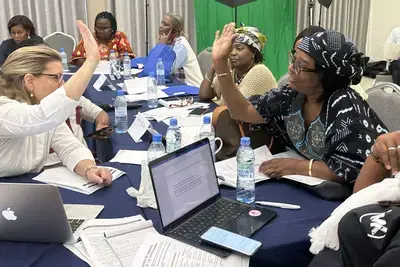 An ADCI candidate in Cocody (a district of Abidjan) and the NDI facilitator shake hands after brainstorming potential campaign messages together.
