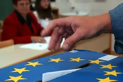 A Slovenian casts his ballot in a box bearing a European Union crest at a polling station in Grosuplje near Ljubljana, Sunday, Oct. 3, 2004. Credit: AP Photo/Darko Bandic