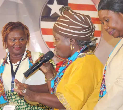 A Liberian woman practices her public speaking skills during a workshop