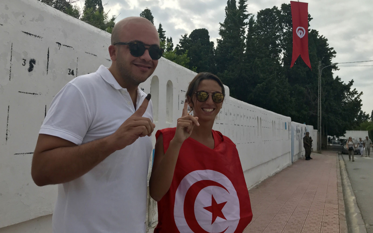 Tunisian voters display inked fingers indicating they've voted in the September 15, 2019, presidential election.